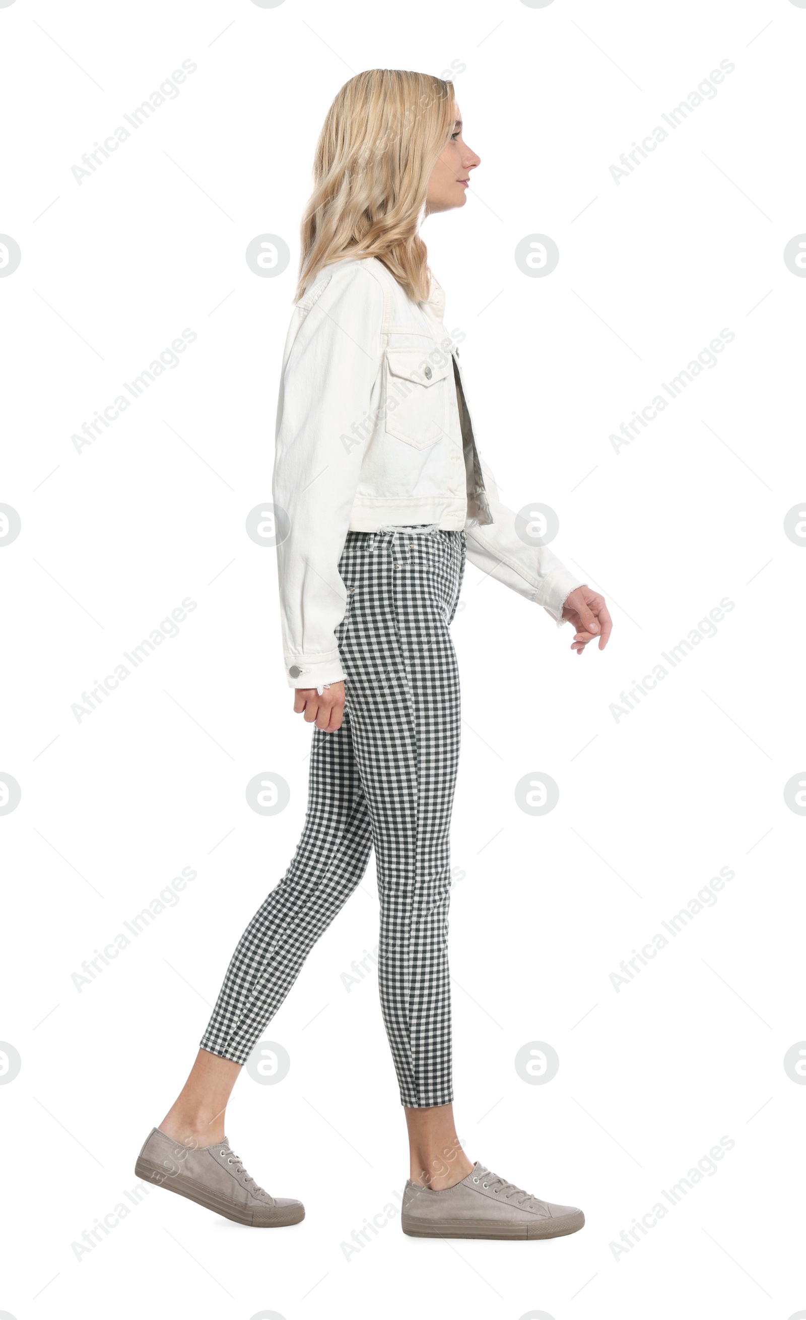 Photo of Beautiful young woman walking on white background