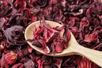 Photo of Wooden spoon with dry hibiscus tea, closeup