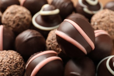 Photo of Many different delicious chocolate truffles, closeup view