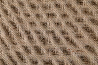Photo of Brown burlap fabric as background, top view