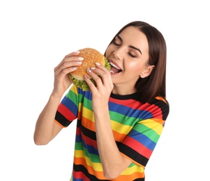 Photo of Young woman eating tasty burger on white background
