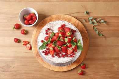 Photo of Delicious homemade cake with fresh berries on wooden table, top view