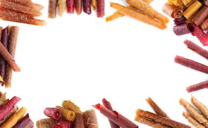 Image of Frame made of delicious fruit leather rolls on white background