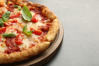 Photo of Delicious Margherita pizza on grey table, closeup. Space for text