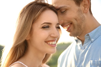 Photo of Cute young couple in love posing outdoors on sunny day