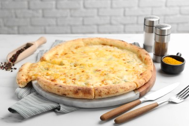 Photo of Delicious cheese pizza served on white table