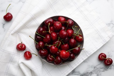 Photo of Fresh ripe cherries with water drops on white marble table, flat lay