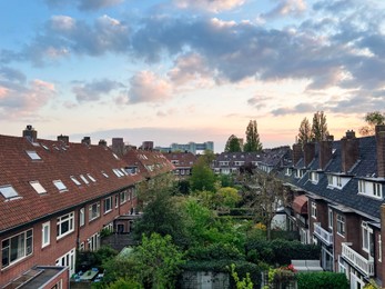 Photo of Residential complex with cozy inner yards under beautiful cloudy evening sky
