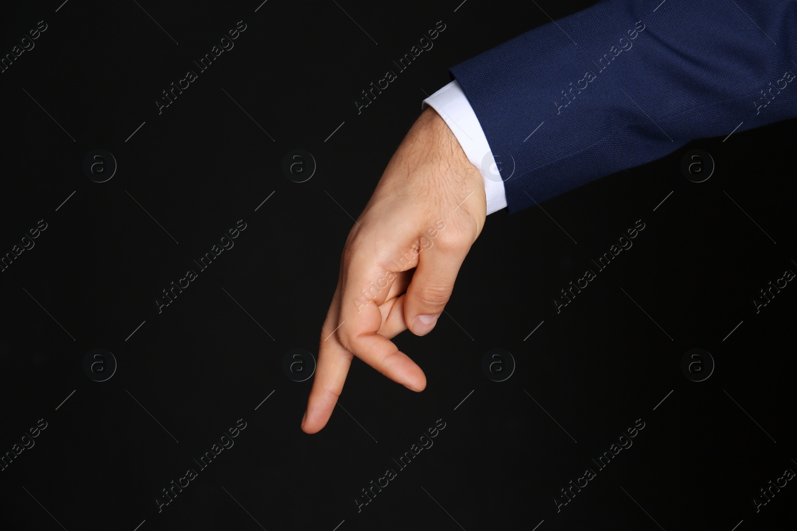 Photo of Businessman imitating walk with hand on black background, closeup. Finger gesture