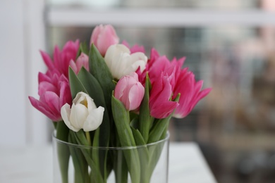 Photo of Bouquet of beautiful tulips on blurred background, closeup