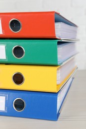 Photo of Stack of office folders on wooden table, closeup