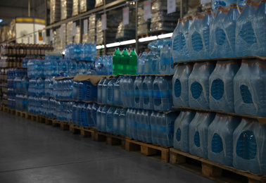 Photo of Many different plastic bottles with water at wholesale market