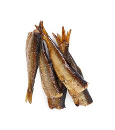 Photo of Many tasty smoked sprats isolated on white, top view