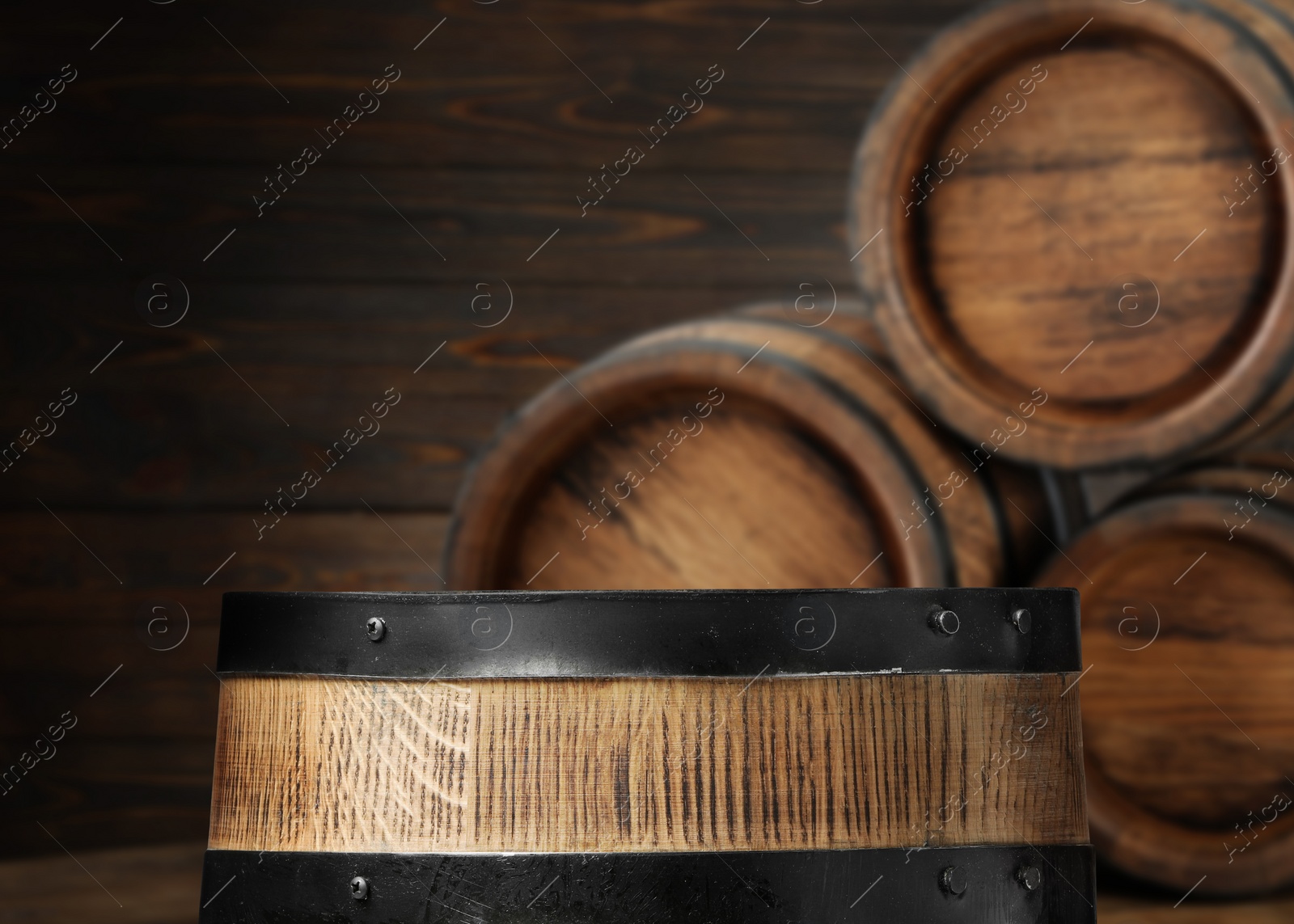 Image of Wooden barrels in cellar, selective focus. Space for text