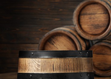 Wooden barrels in cellar, selective focus. Space for text