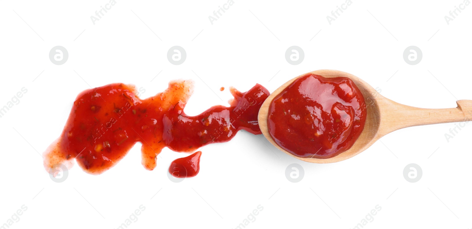 Photo of Wooden spoon and red sauce on white background, top view