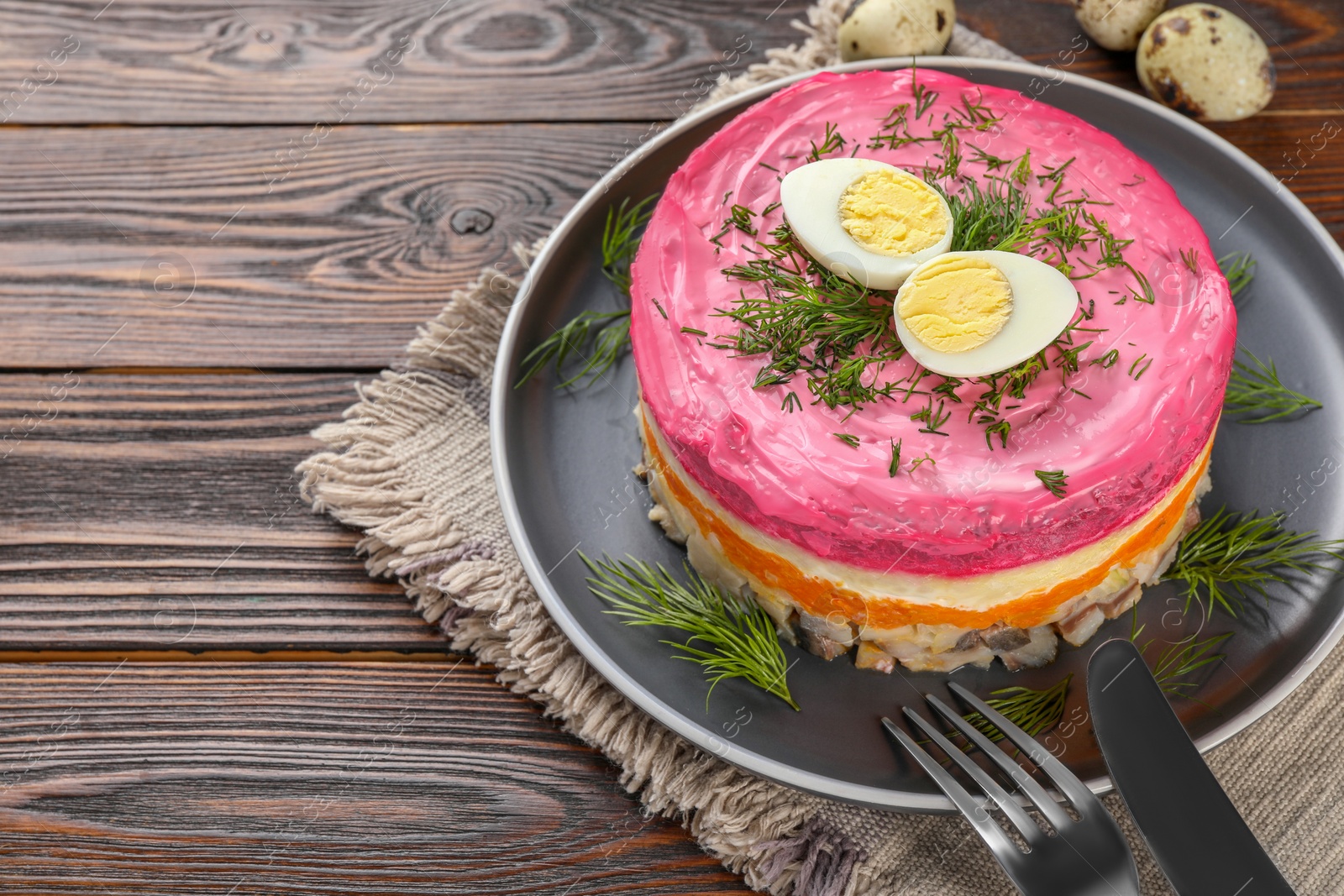 Photo of Herring under fur coat salad served on wooden table, space for text. Traditional Russian dish