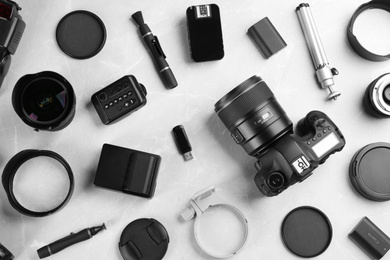 Photo of Flat lay composition with equipment for professional photographer on grey marble table