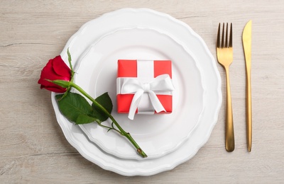 Photo of Beautiful table setting for Valentine's Day dinner on white wooden background, flat lay