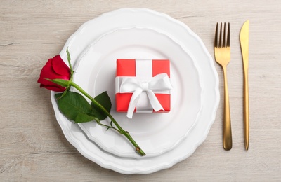 Beautiful table setting for Valentine's Day dinner on white wooden background, flat lay