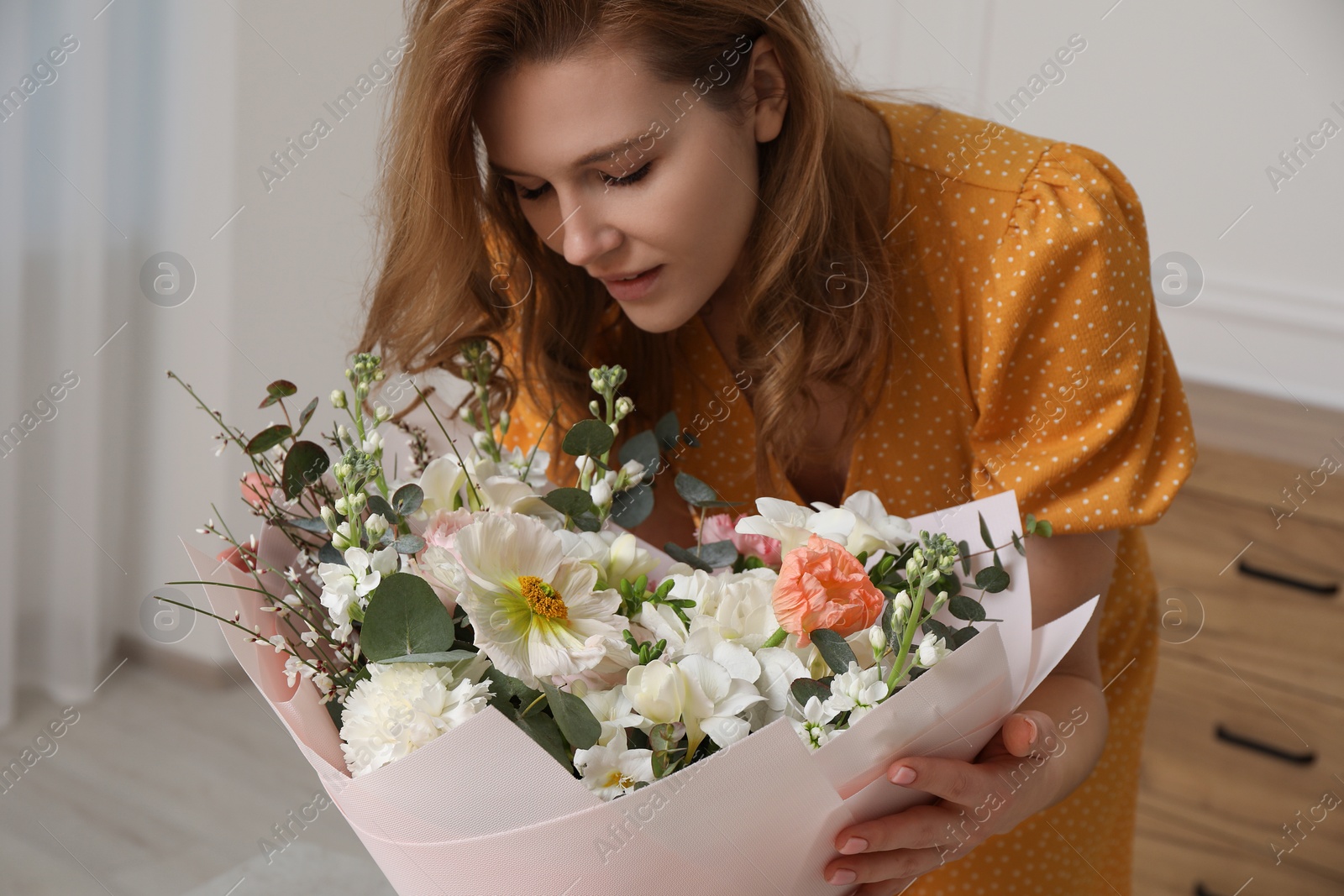 Photo of Beautiful woman with bouquet of flowers indoors