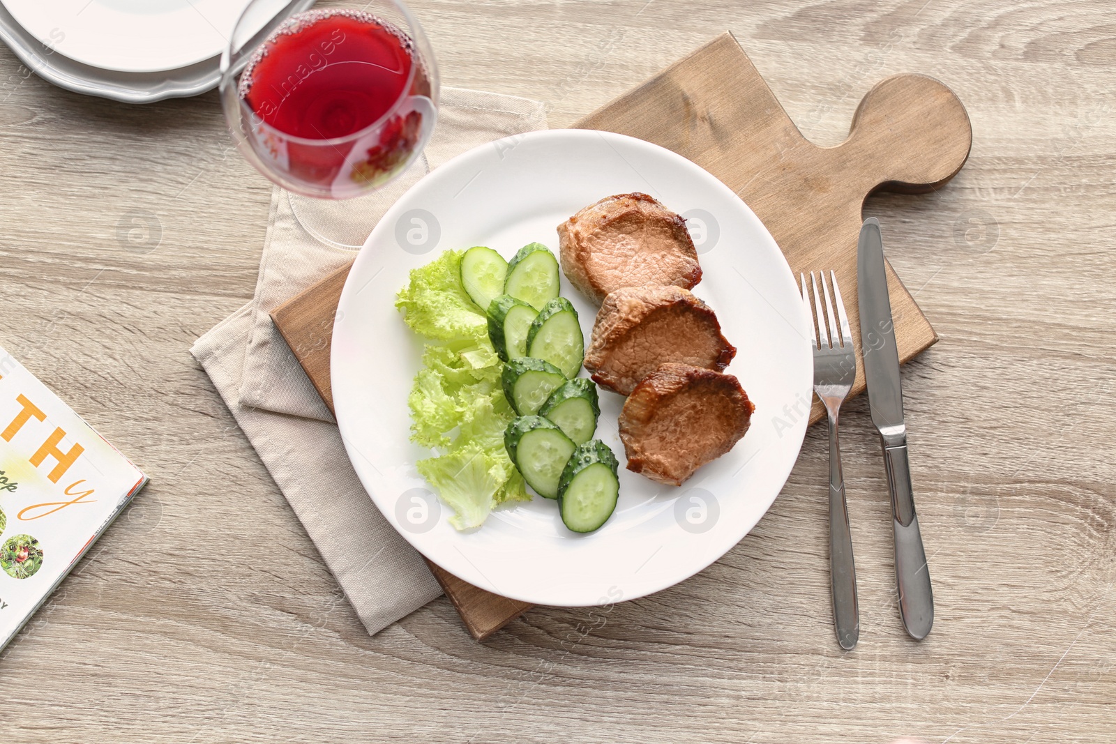 Photo of Plate with delicious meat and vegetables served on wooden table, flat lay