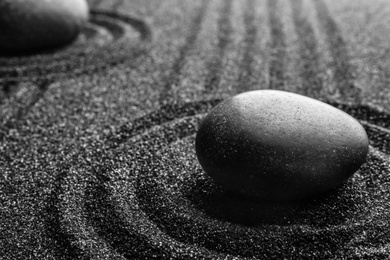 Photo of Black sand with stone and beautiful pattern. Zen concept