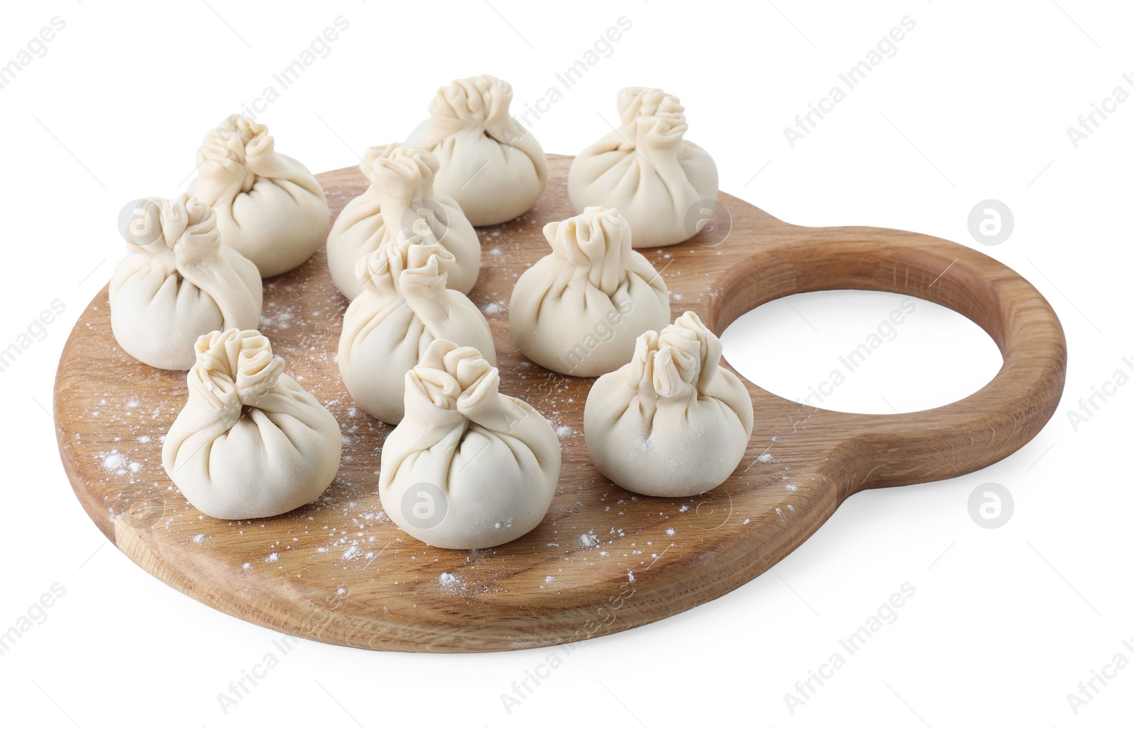 Photo of Wooden board with uncooked khinkali (dumplings) isolated on white. Georgian cuisine