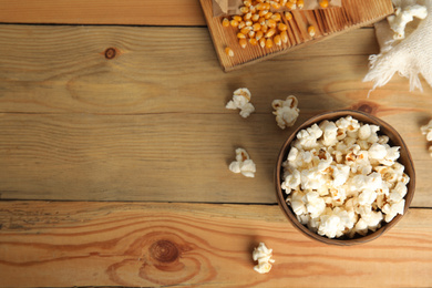 Tasty pop corn on wooden table, flat lay. Space for text