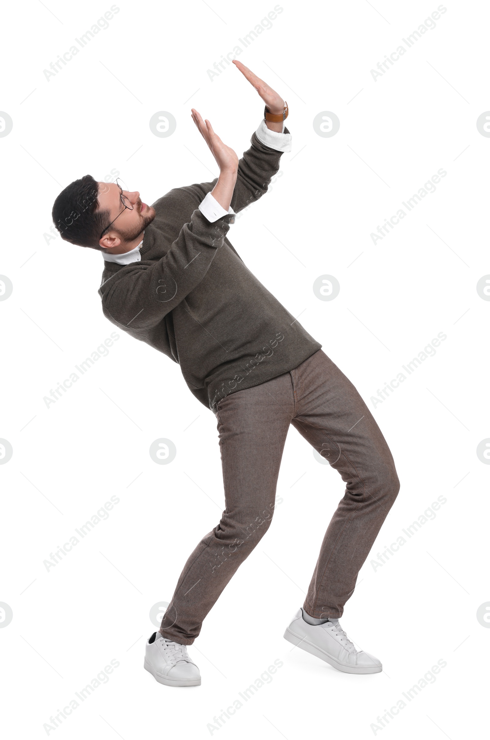 Photo of Handsome bearded businessman in eyeglasses evading something on white background