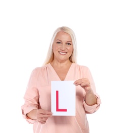 Happy mature woman with L-plate on white background. Getting driving license