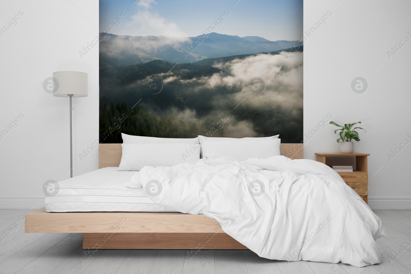 Image of Light bedroom. Interior with comfortable bed and mountain landscape wallpapers