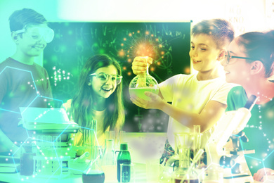 Image of Smart pupils making experiment in chemistry class