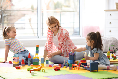 Mother playing with her children at home