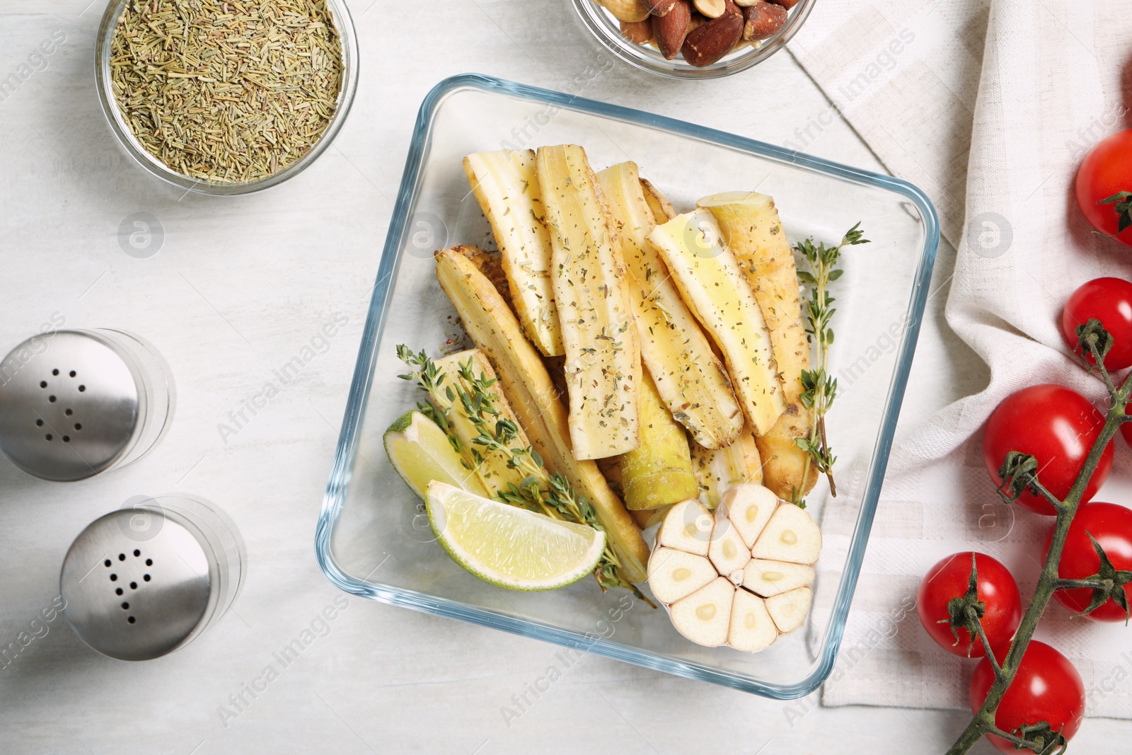 Photo of Flat lay composition with raw cut white carrot in baking dish on wooden table