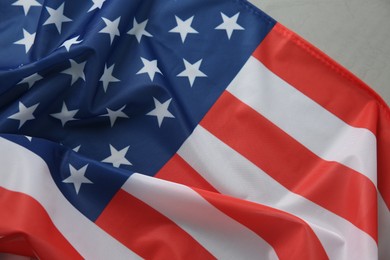 Photo of Flag of USA on light grey table, top view