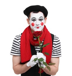 Funny mime artist with red rose on white background