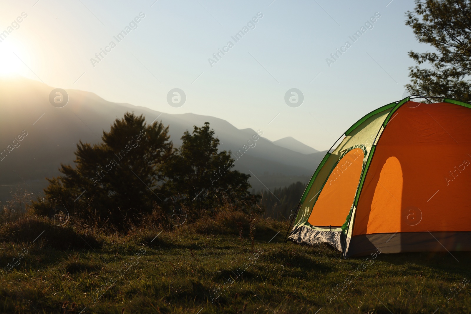 Photo of Color camping tent on hill in mountains