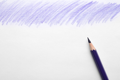 Photo of Purple pencil on sheet of paper with drawing, top view. Space for text