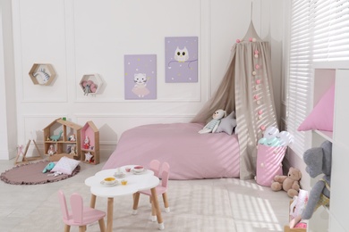 Cute child's room interior with toys and modern furniture