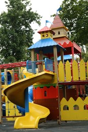Children's playground with bright slide on summer day