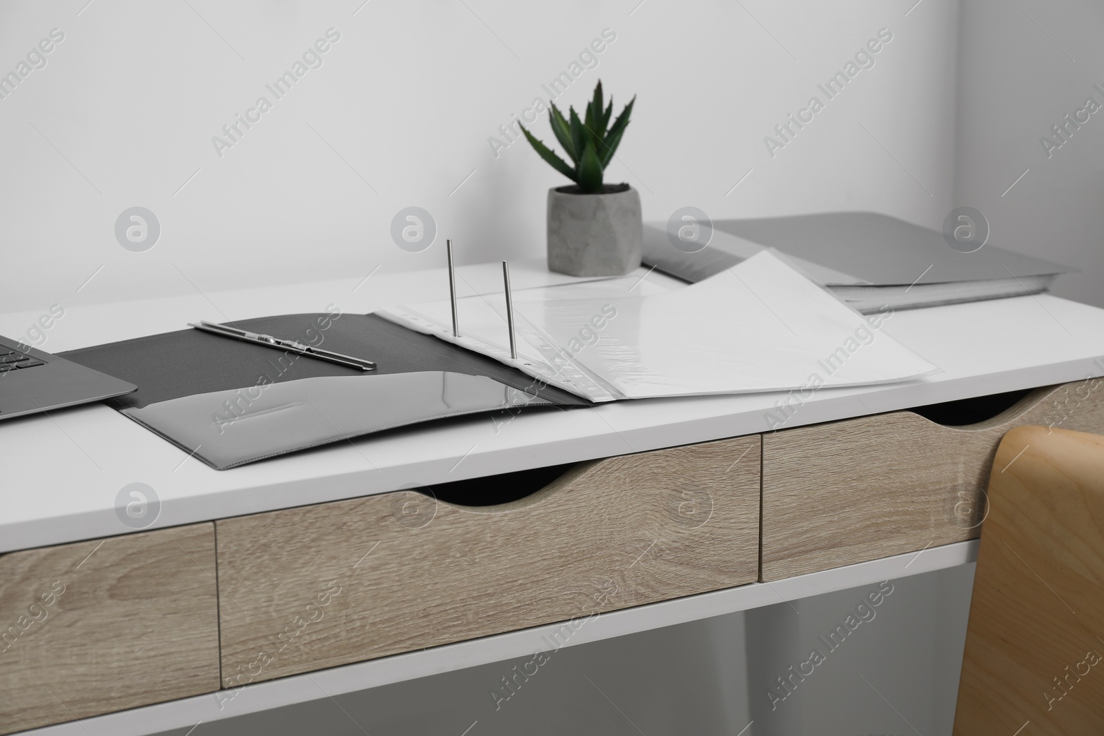 Photo of File folder with punched pockets on white table in office