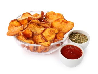 Bowl of sweet potato chips with sauce and herbs isolated on white