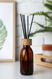 Photo of Air reed freshener on white table indoors