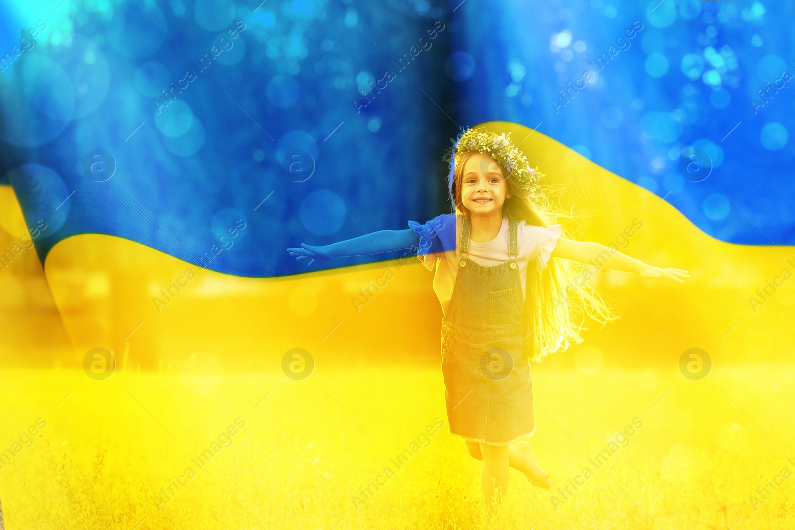Image of Double exposure of adoracble little girl with flower wreath running outdoors and Ukrainian flag 