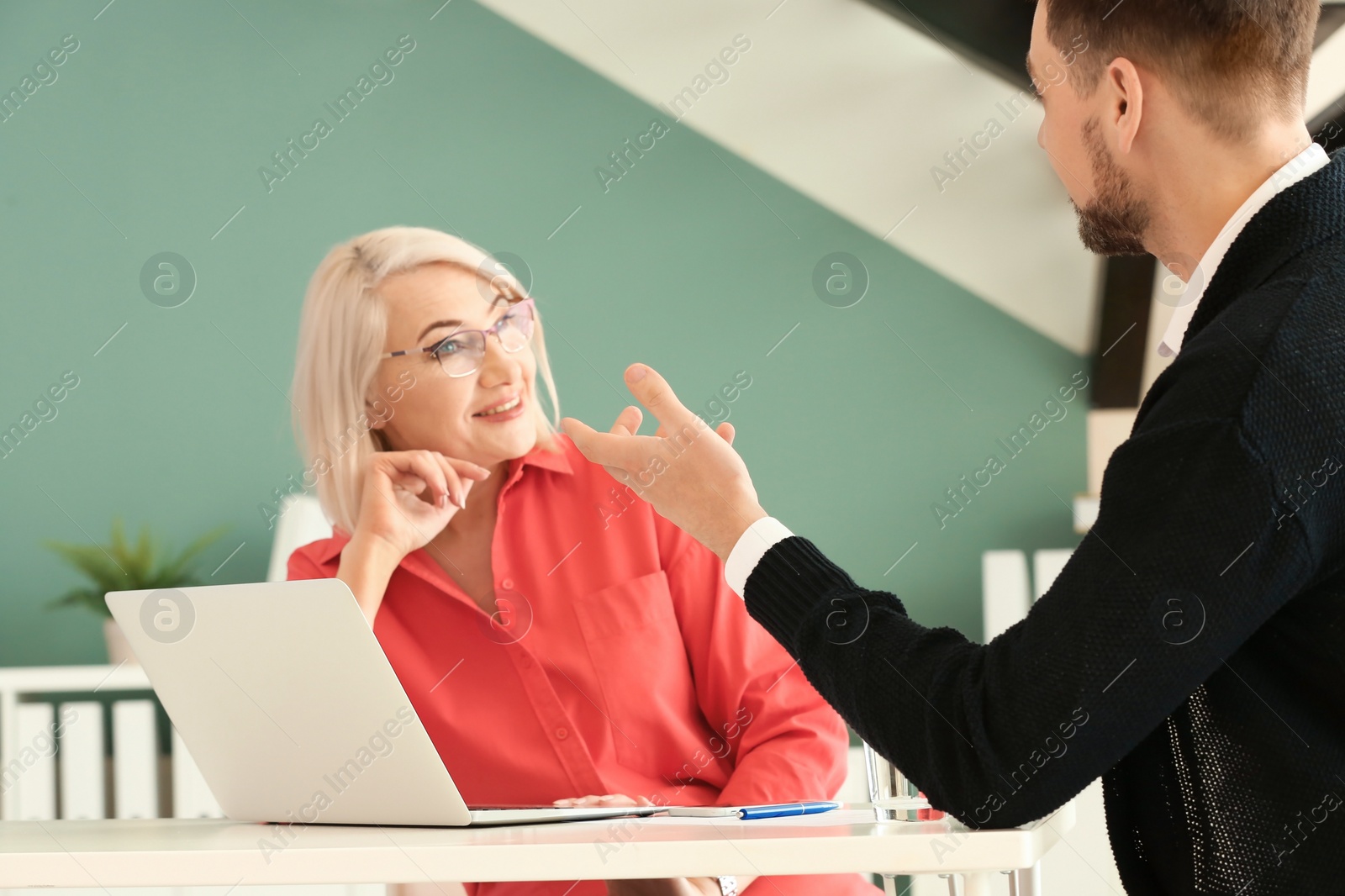 Photo of Mature woman consulting with man in office