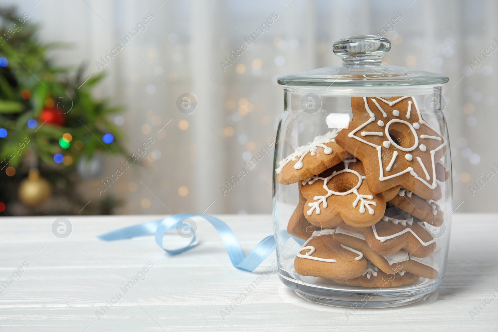 Photo of Glass jar with tasty homemade Christmas cookies on table