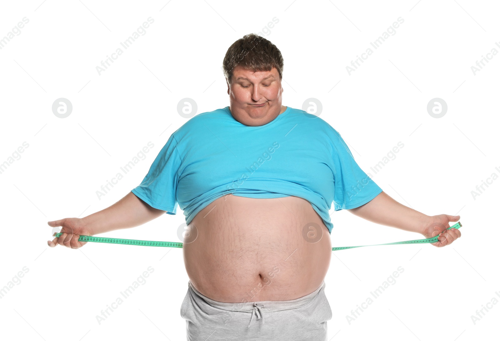 Photo of Emotional overweight man with measuring tape on white background