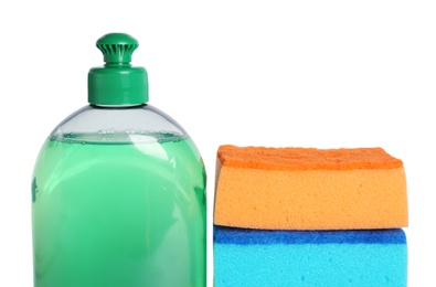 Bottle of detergent and sponges on white background