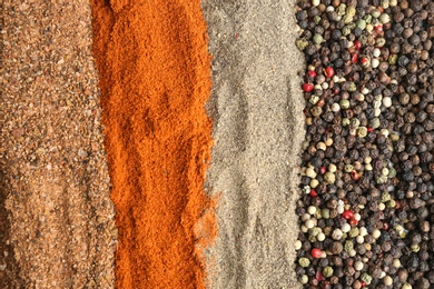 Photo of Different ground peppers and corns as background, closeup